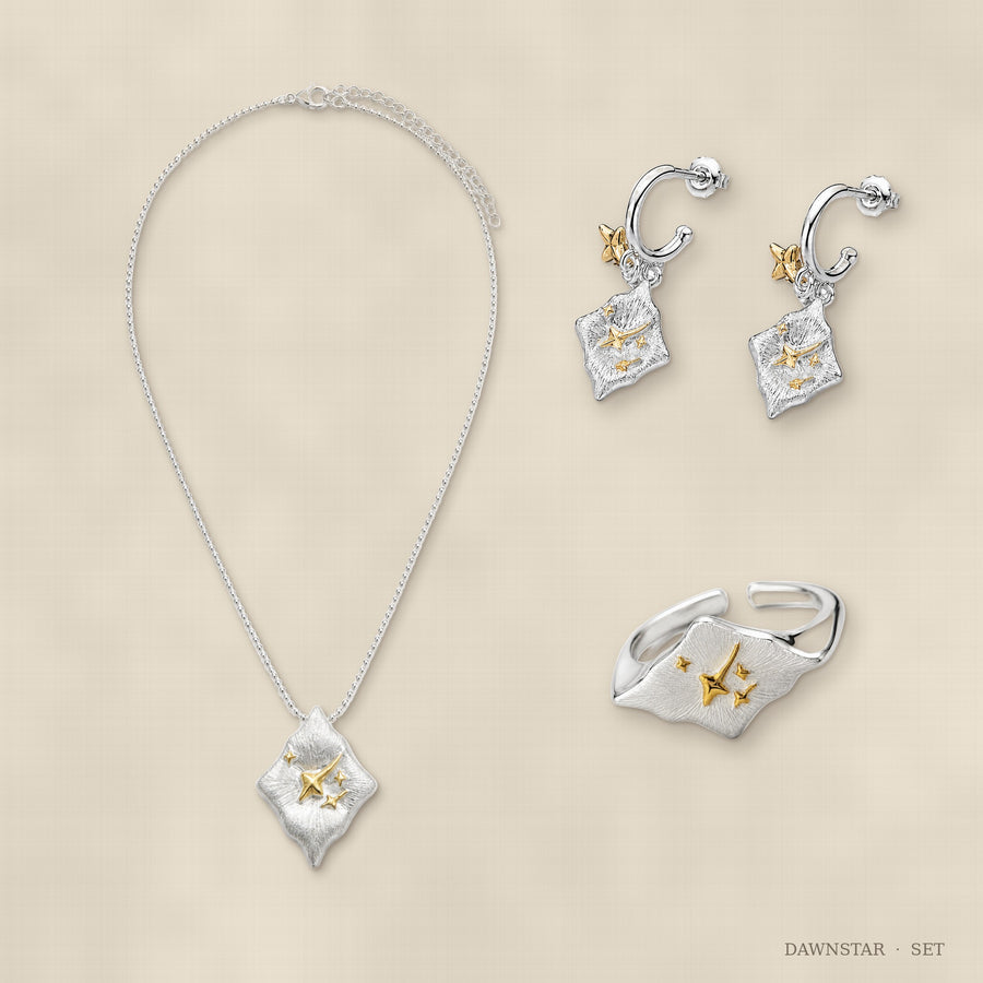Dawnstar jewelry set flat lay – ring, earrings and necklace arranged together