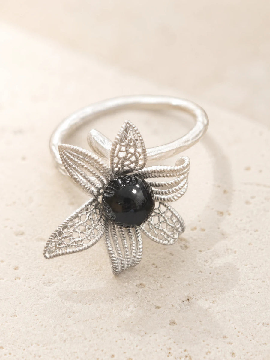 Noir Bloom floral ring with dark center stone