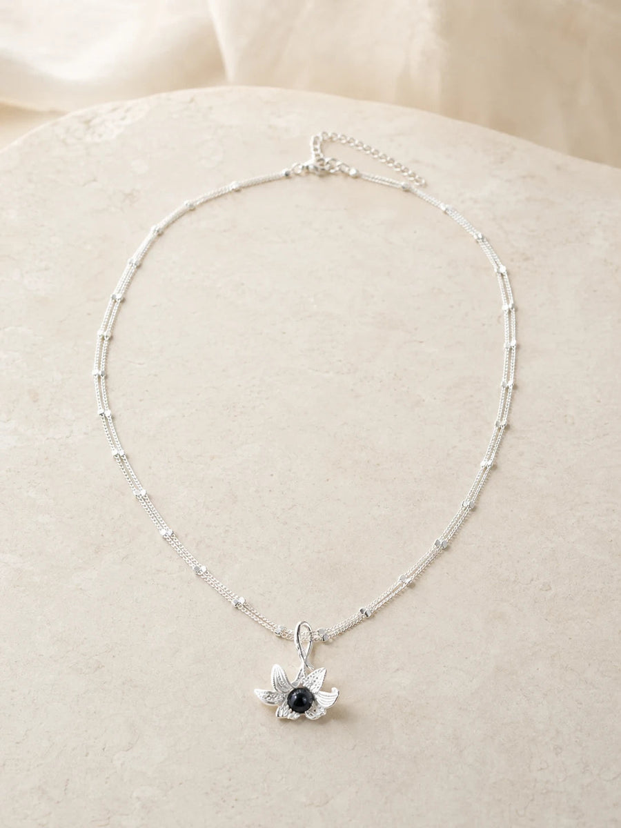 Noir Bloom floral necklace with dark center stone