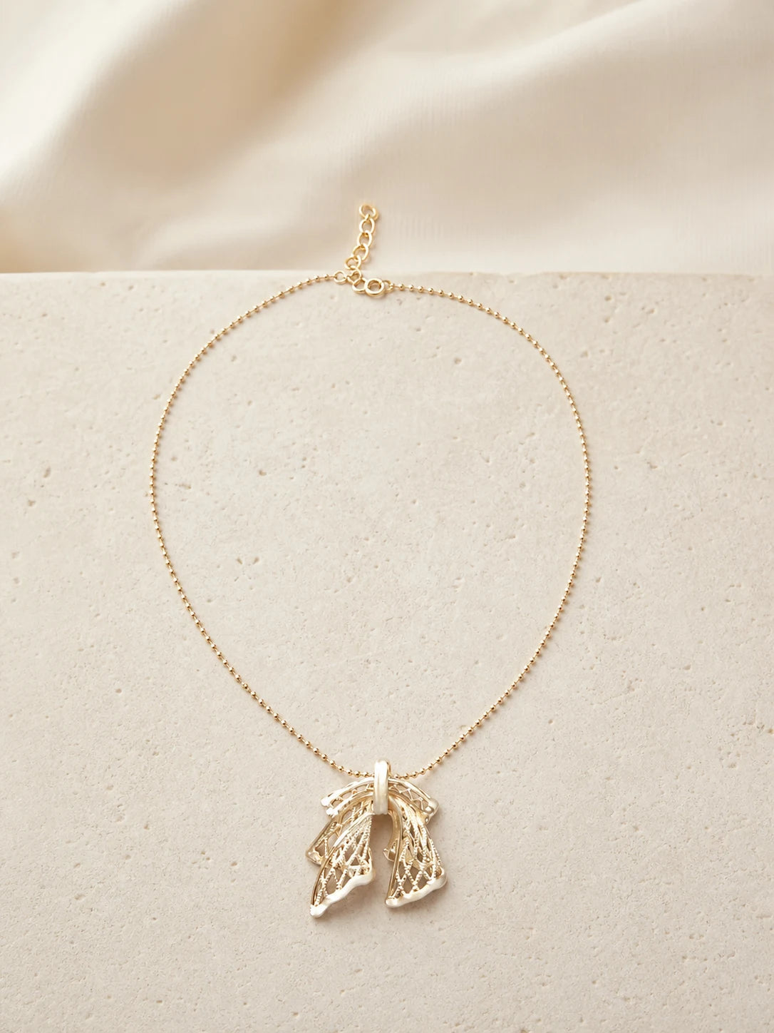 Silken Letter gold-toned wing necklace