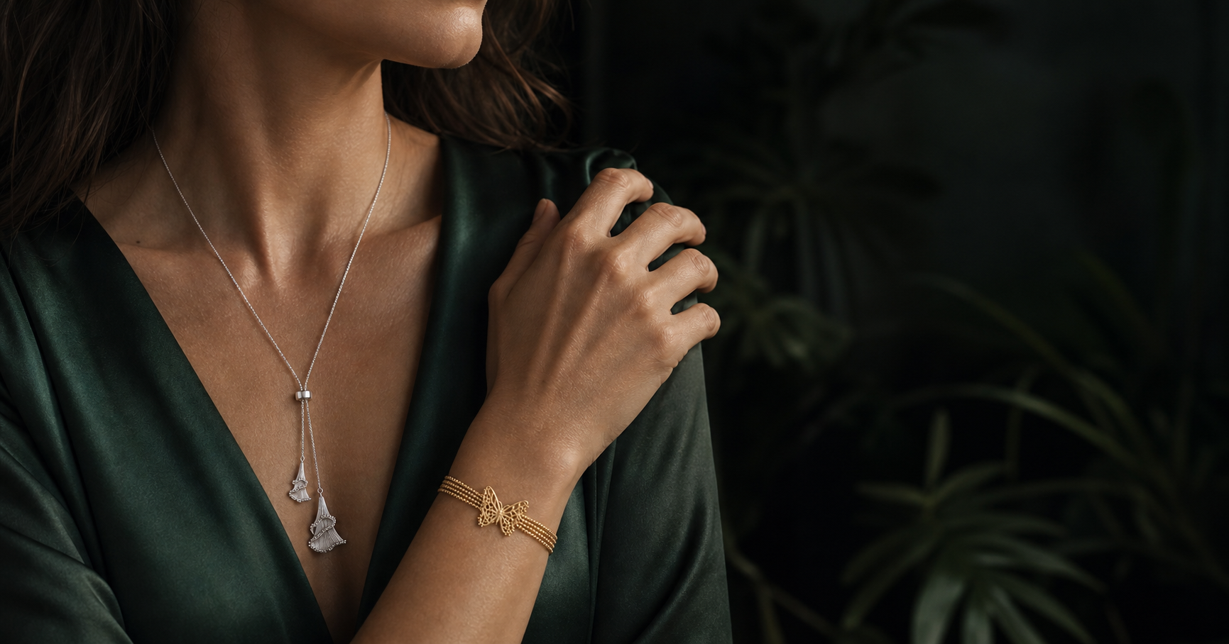 Woman wearing the silver Ginkgo Waltz double-drop necklace and gold Butterfly Lace bracelet